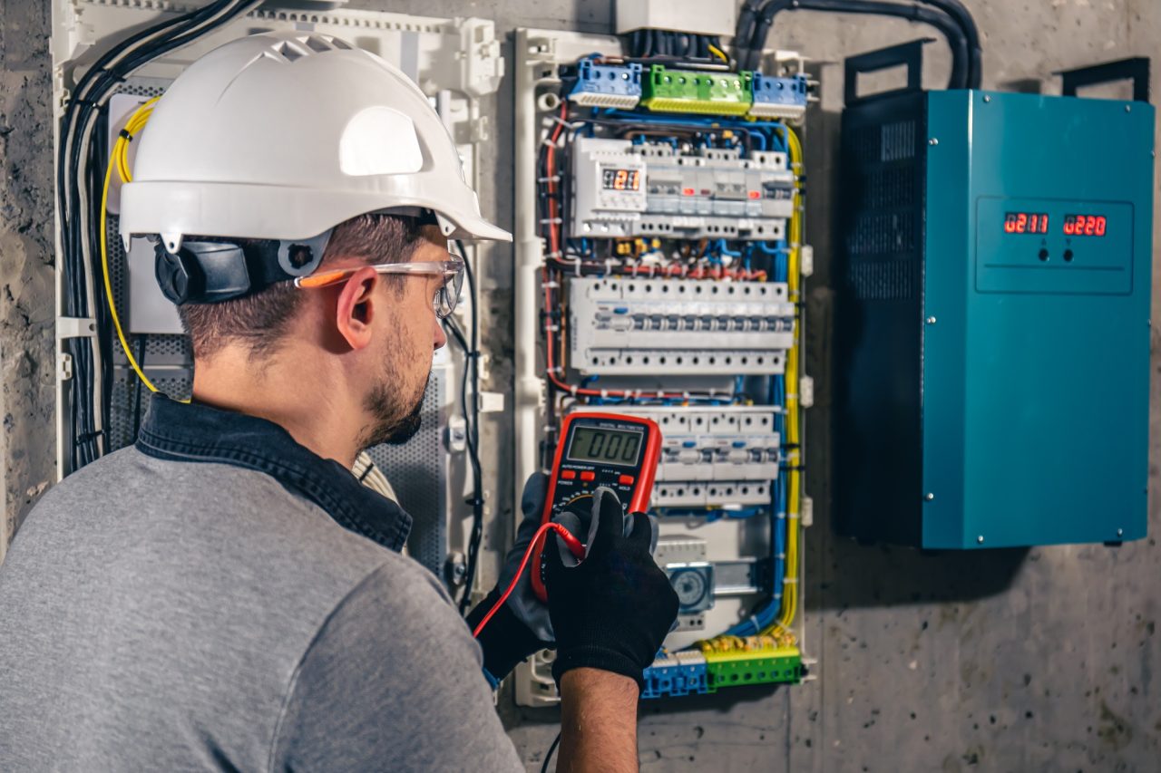 man-an-electrical-technician-working-in-a-switchboard-with-fuses-1-1.jpg